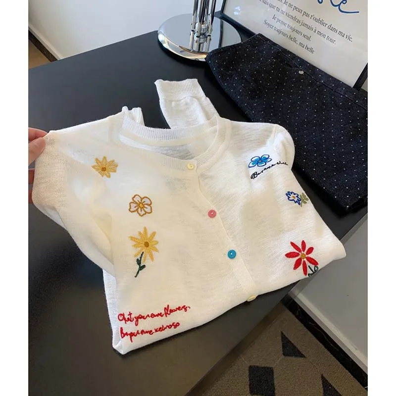 White embroidered sun-proof knitted cardigan women's summer thin 2026 new air-conditioned blouse with short blouse.