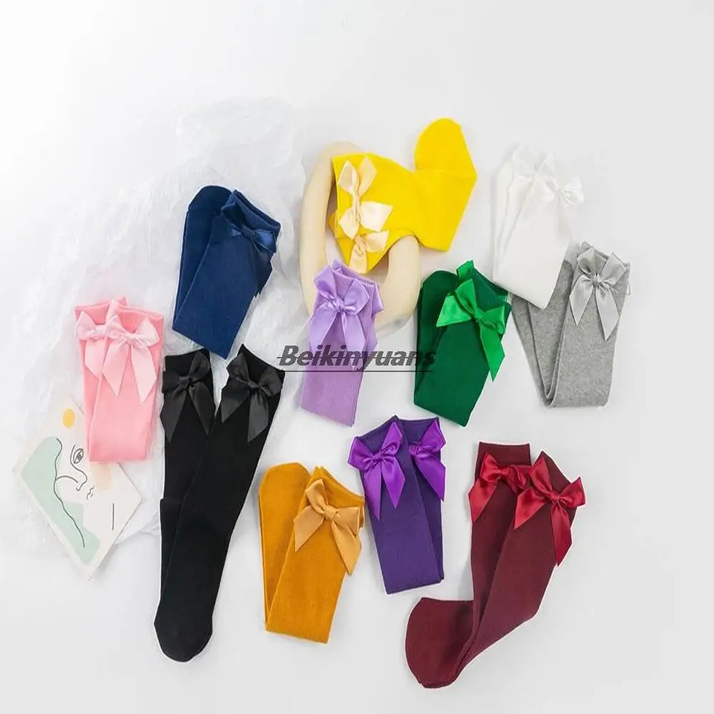 

New children's bow candy-colored pile socks Korean cute straight socks can wear solid cotton stockings before and after.