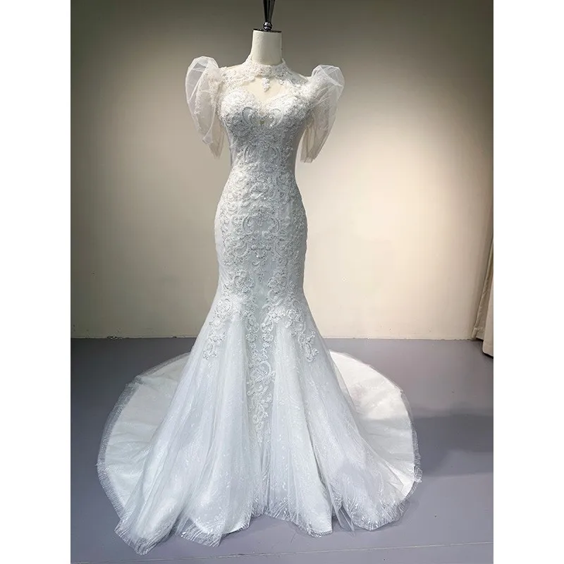 

A new luxurious heavily handcrafted short-sleeved lace dress with light tulle fishtail and main