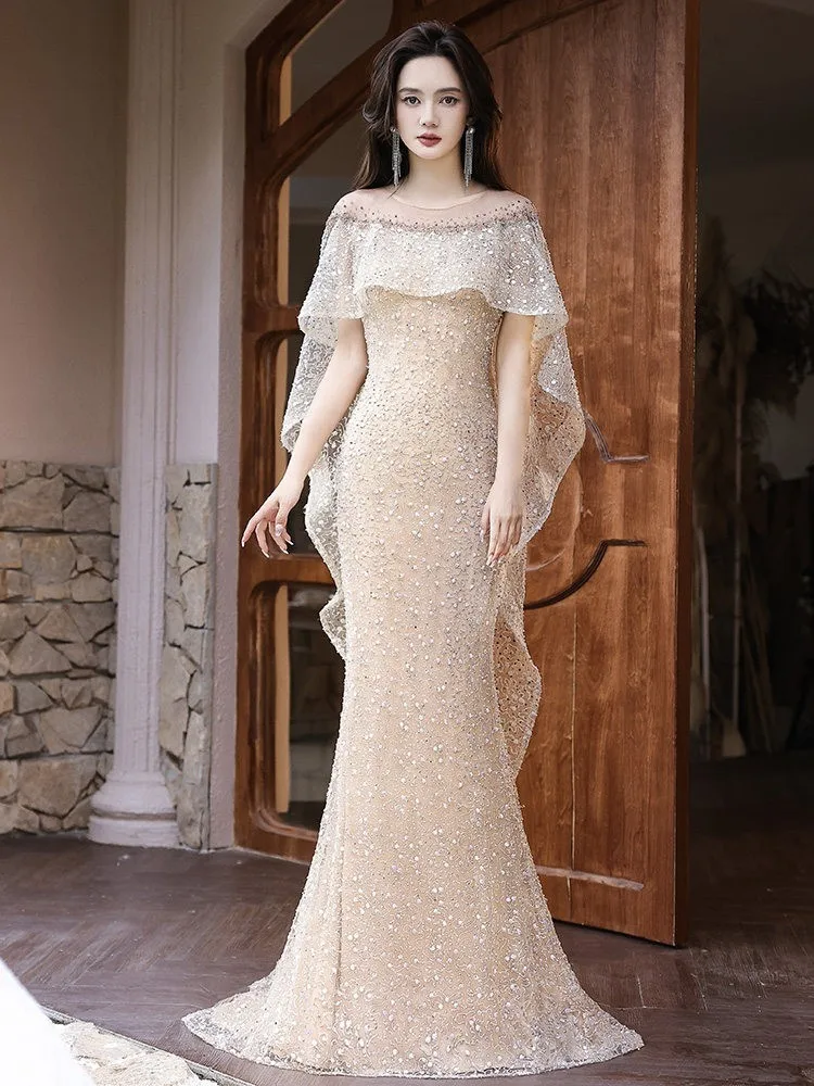 

A champagne-colored elegant and luxurious fishtail dress for the host of light luxury event