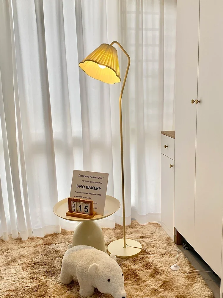 Floor lamp next to the sofa in the cream style living room, French high aesthetic value, simple modern pleated decoration