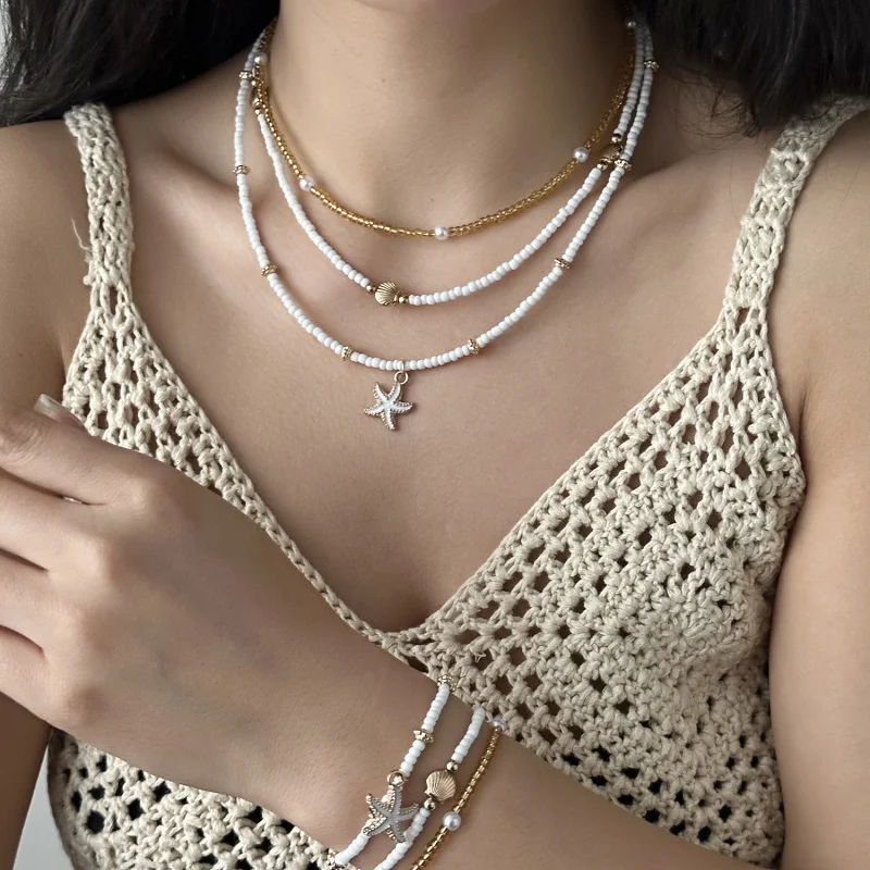 This Bohemian-style beach-themed multi-layer necklace with imitation shell and starfish beads is an excellent gift for ladies.