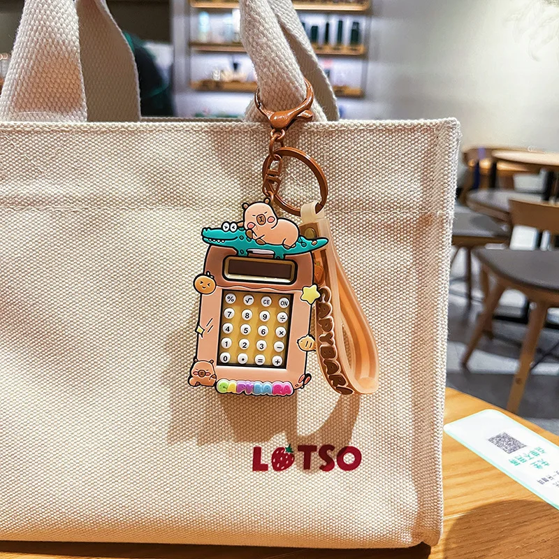 2025 nuevo llavero de calculadora Capibala lindo llavero de capibara de dibujos animados estudiante mochila colgante temporada escolar pequeño regalo