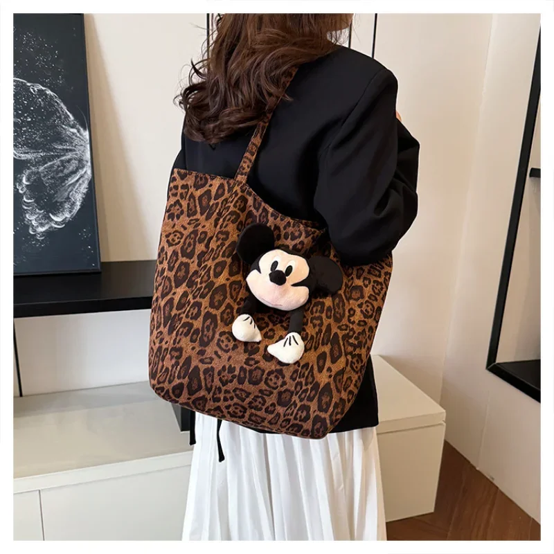 

Disney Mickey's new niche leopard print fashion canvas bag, tote shoulder large-capacity portable commuter plush bag.