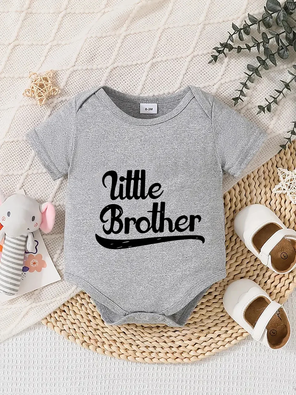 Playful letter-printed baby short-sleeve triangle bodysuit. Button closure for easy dressing, machine washable