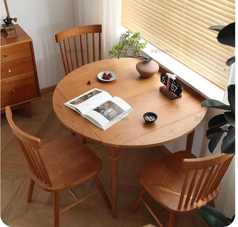 

Nordic solid wood dining table folding round table dining home small cherry wood dining table and chair.