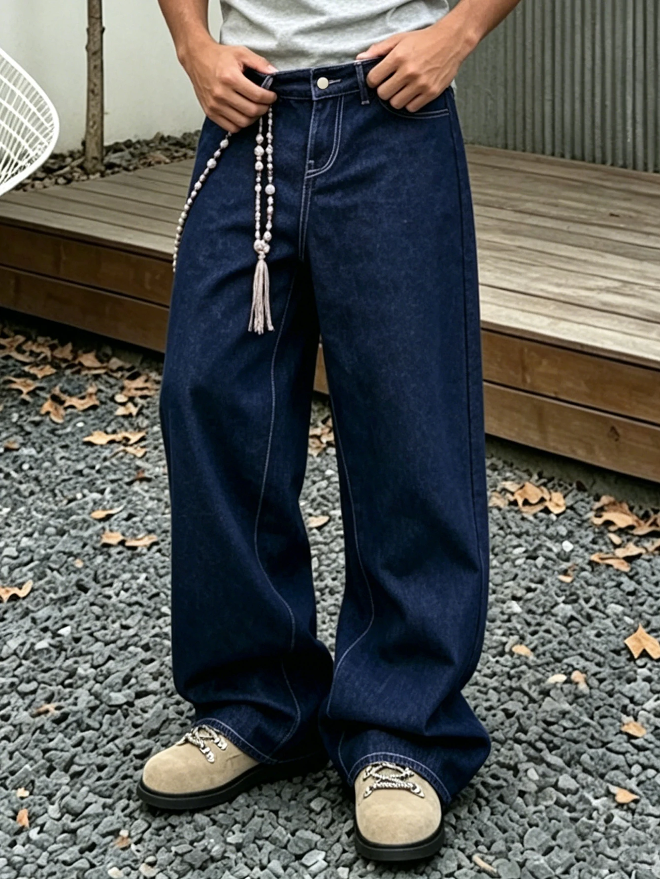 

Denim blue dark topstitched wide-leg jeans are the same for men and women. They are high-waisted, loose and floor-length. They a