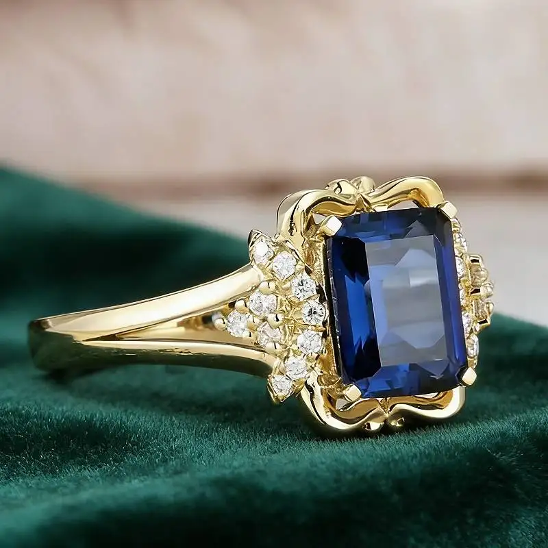 Huitan Ästhetischer Damenring in Goldfarbe mit eingelegtem leuchtend blauem Zirkonia, modisches Damen-Accessoire, Partyschmuck für die Hochzeit