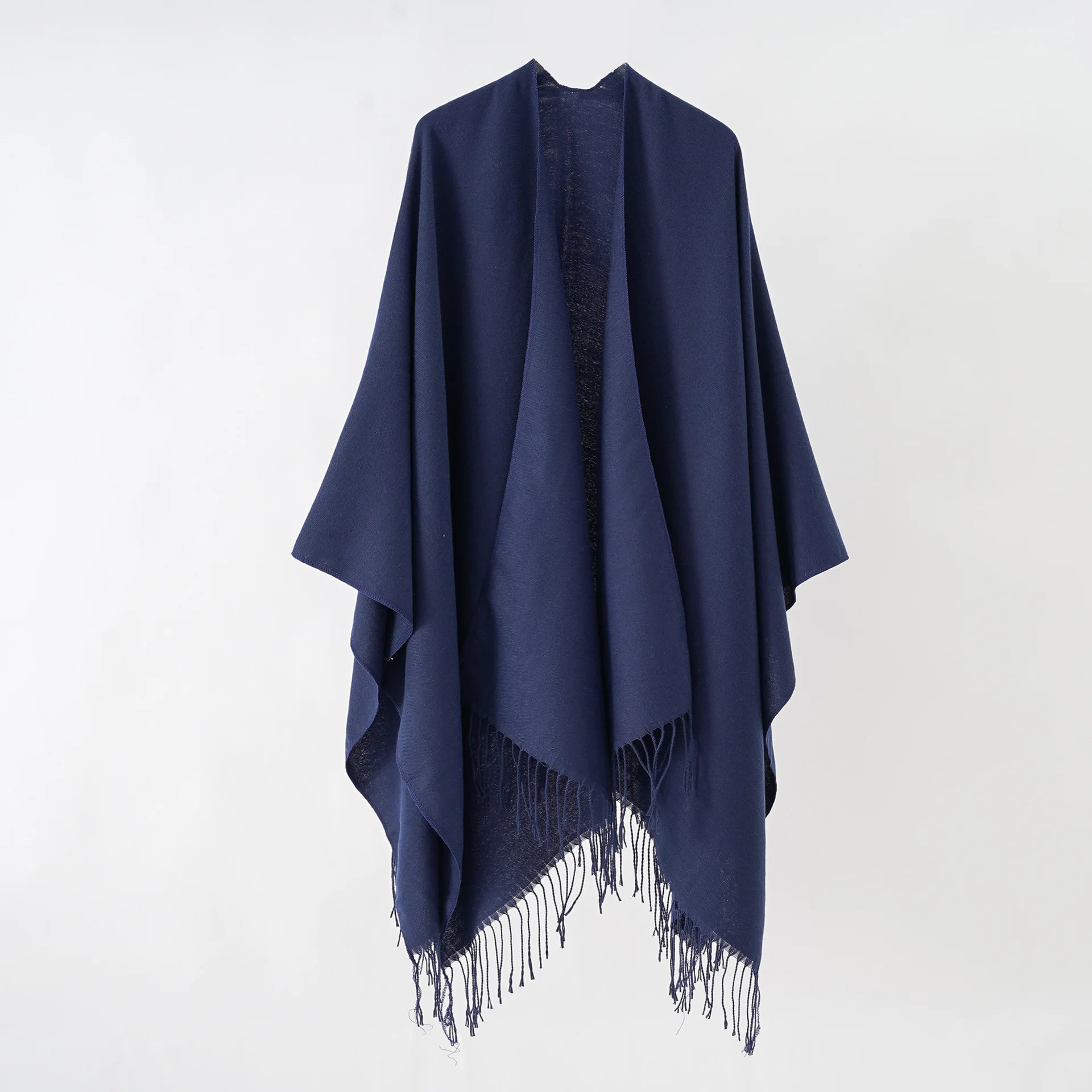 A woman\'s shawl a plain-colored, monochrome cape with a large split shawl and imitation cashmere tassels