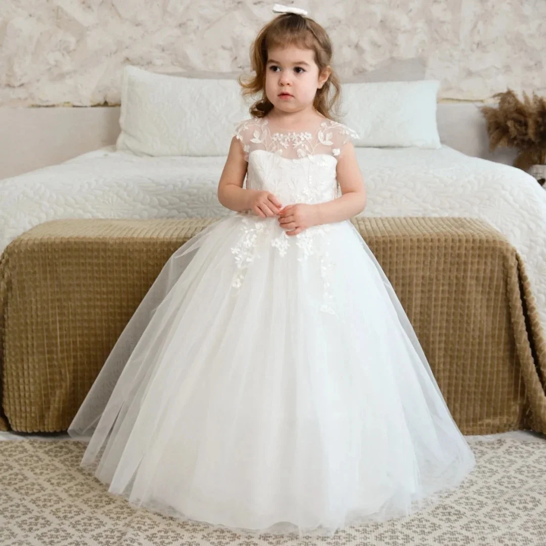 فستان فتاة الزهور البيضاء المخصص من التول مزين بالزهور مع فيونكة بدون أكمام لحفلات الزفاف وأعياد الميلاد وحفلات التواصل المقدس