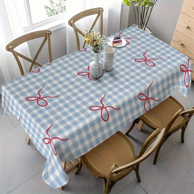 One rectangular tablecloth with blue and white checkered pattern and a bow at the corner, made of polyester material.