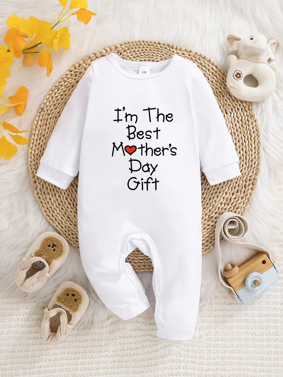 A baby long-sleeved onesie with interesting letter prints. It features a buttoned design for easy putting on and taking off
