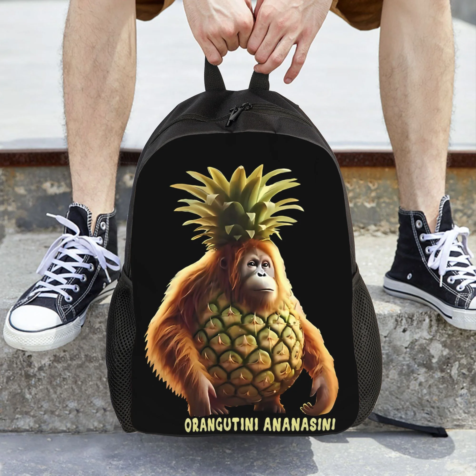 

Rhesus Backpack - Black color, featuring cartoon-like rhesus and pineapple designs, a durable fabric school bag suitable