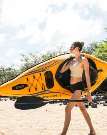 Girl carrying Kayak