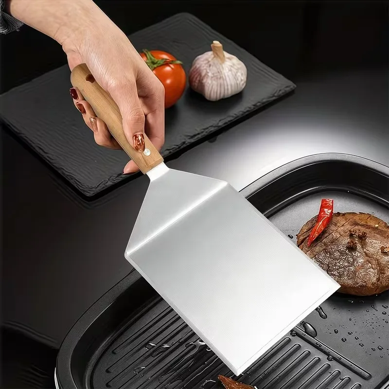 Stainless steel multi-functional cooking spatula – ideal for grilling and searing steaks, suitable for home and outdoor use.
