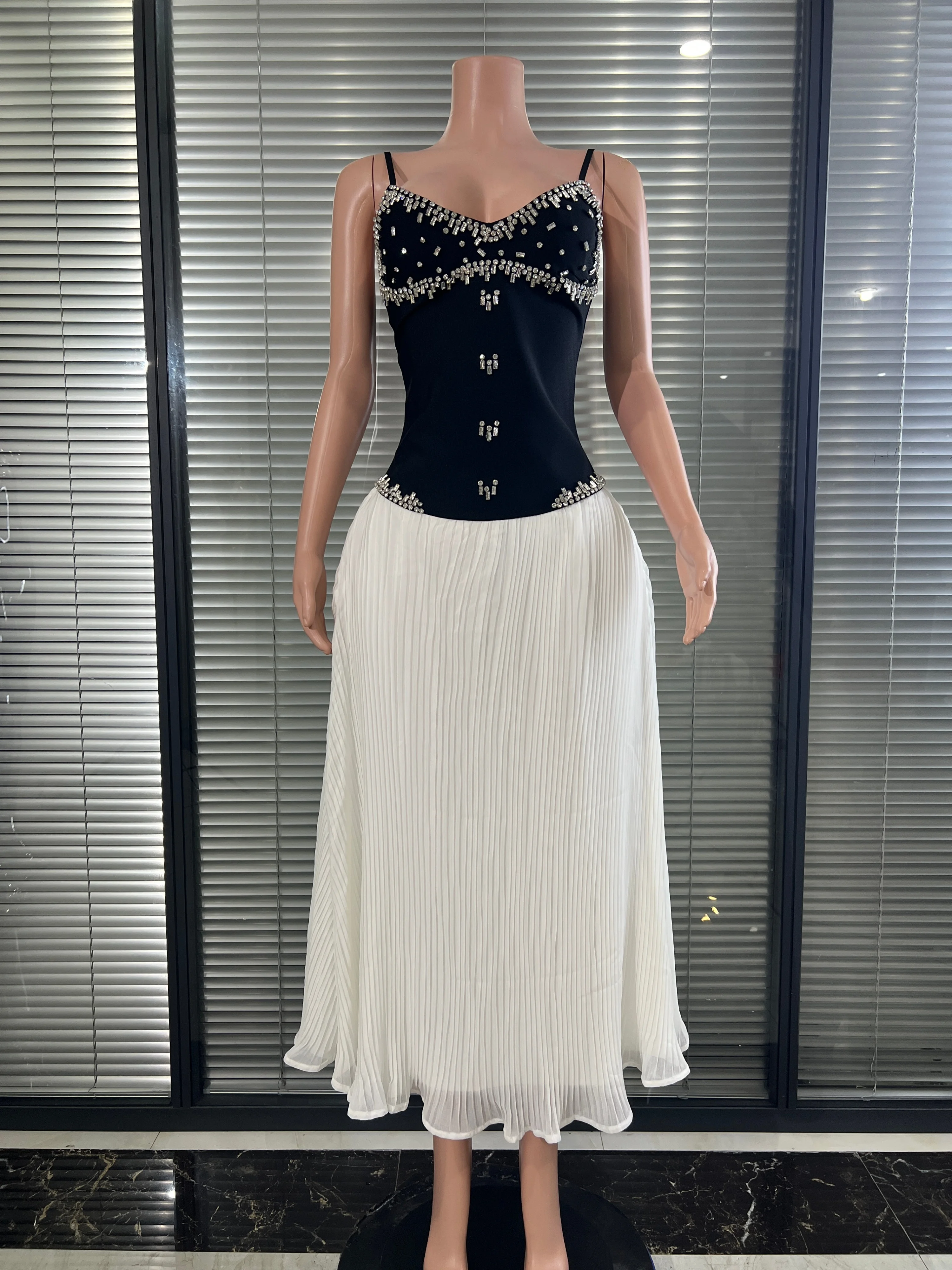 Luxurious crystal and rhinestone decorated  flowing white chiffon evening dress.outfit for a formal ladies' birthday photo shoot