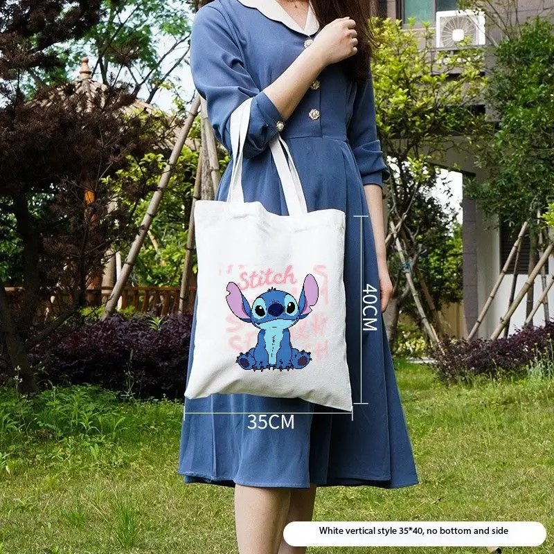 حقائب اليد المصنوعة من القماش باللونين البيج والأسود من Lilo & Stitch - رسم توضيحي لشخصية الغرز الملونة، اقتباس تحفيزي 'معرف ماذا أنت #6