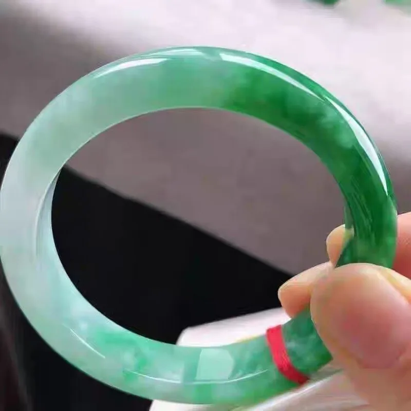 jadeite   ice-type  with floating inclusions  perfectly  oval-shaped  and round green jade bracelet