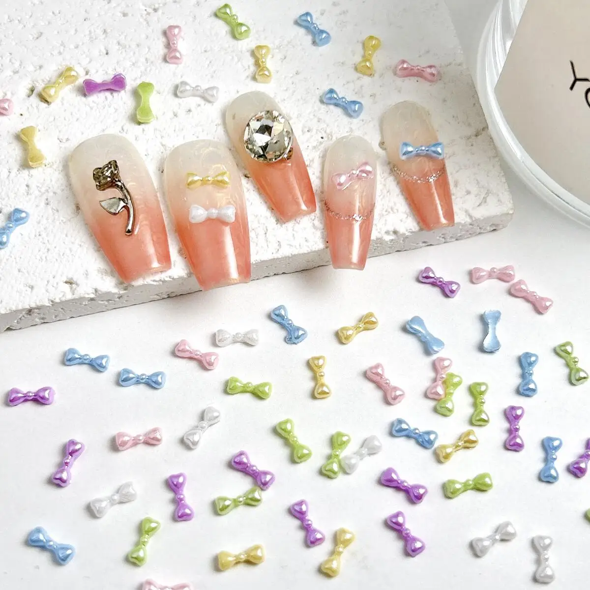 โบว์เรซิ่นขนาดเล็กน่ารัก 100 ชิ้น สีพื้น แต่งเล็บ สไตล์หวาน สำหรับตกแต่งเล็บ ทำเคสมือถือ และงานประดิษฐ์อื่นๆ