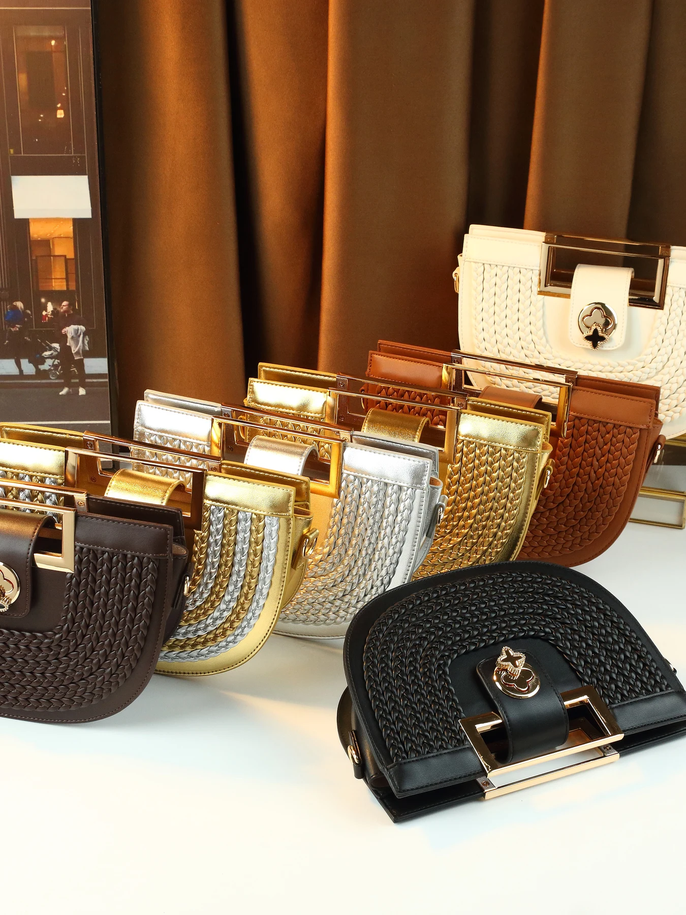 European and American trendy hand-woven saddle bag women's new four-leaf clover lock portable semi-round bag