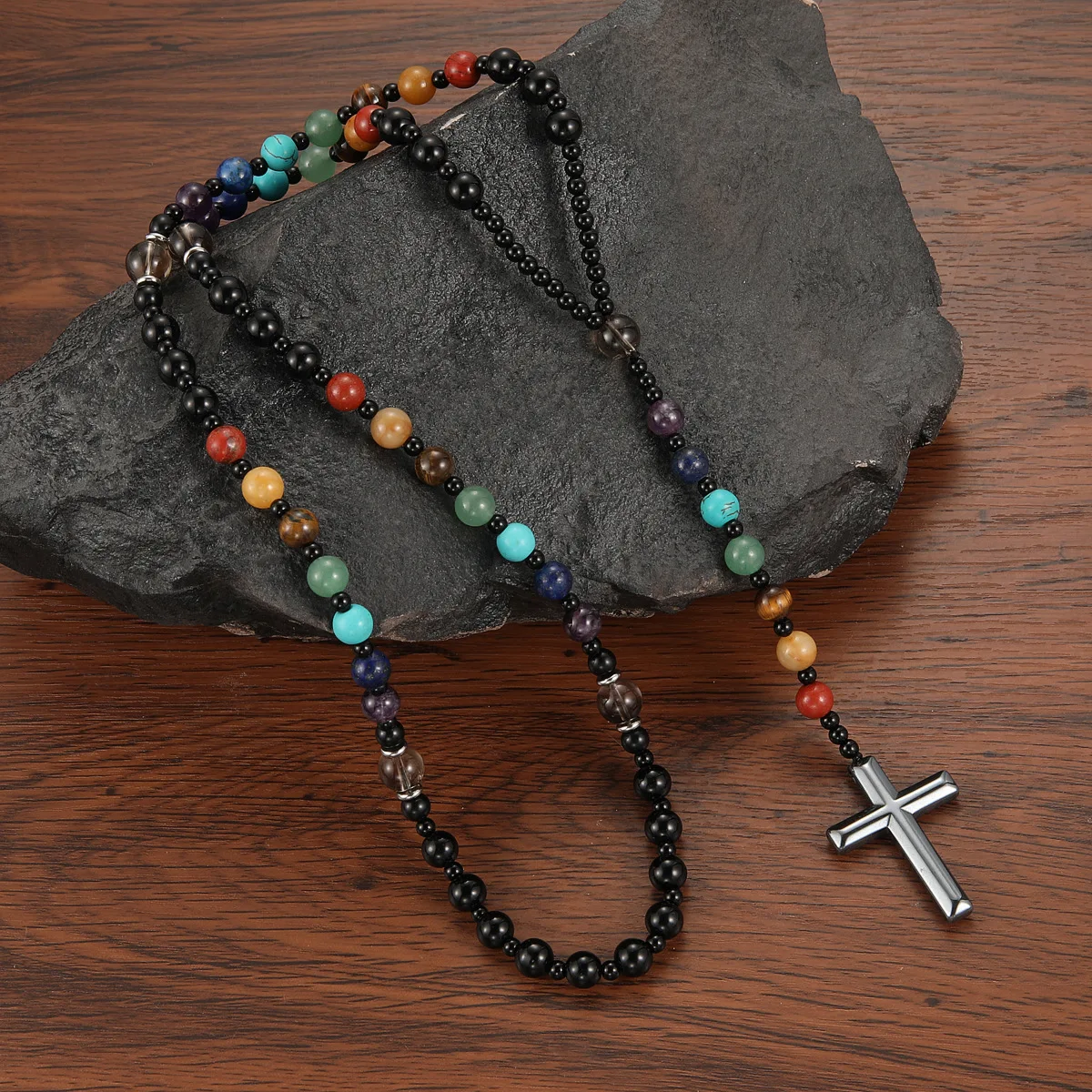 Handcrafted geometric cross pendant necklace featuring vibrant natural stone beads in soft pink zebra pattern on ballpoint chain