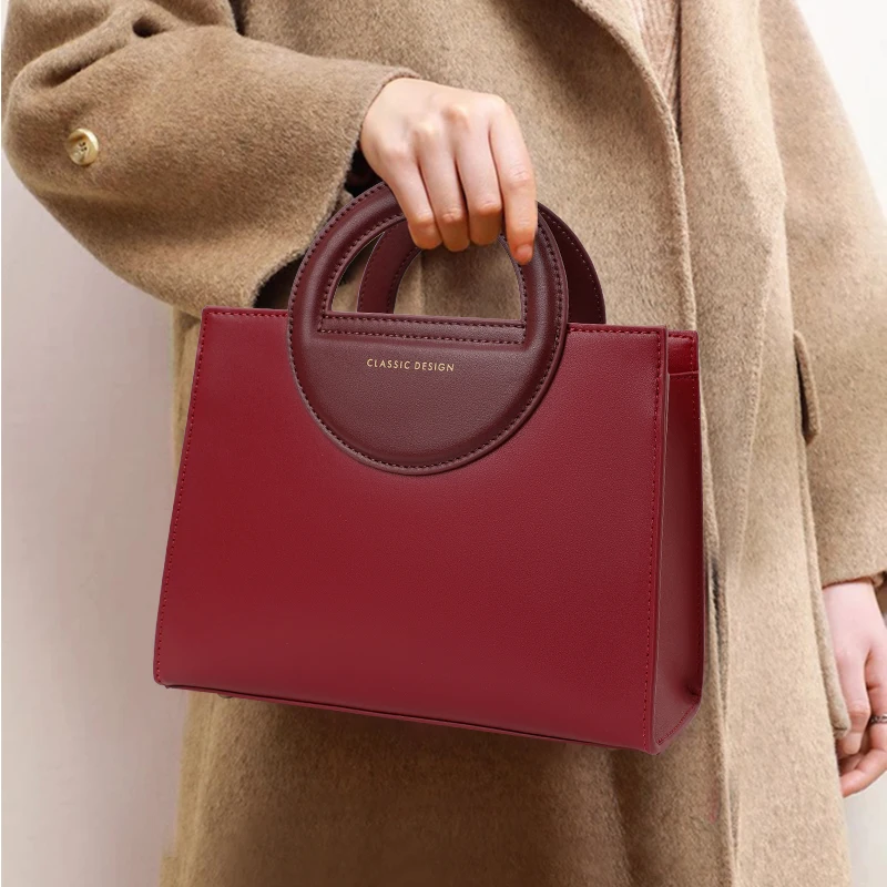 

Aidrani Red Leather Handbag: Contrast Ring Handle, Minimalist Elegance & Brand Identity