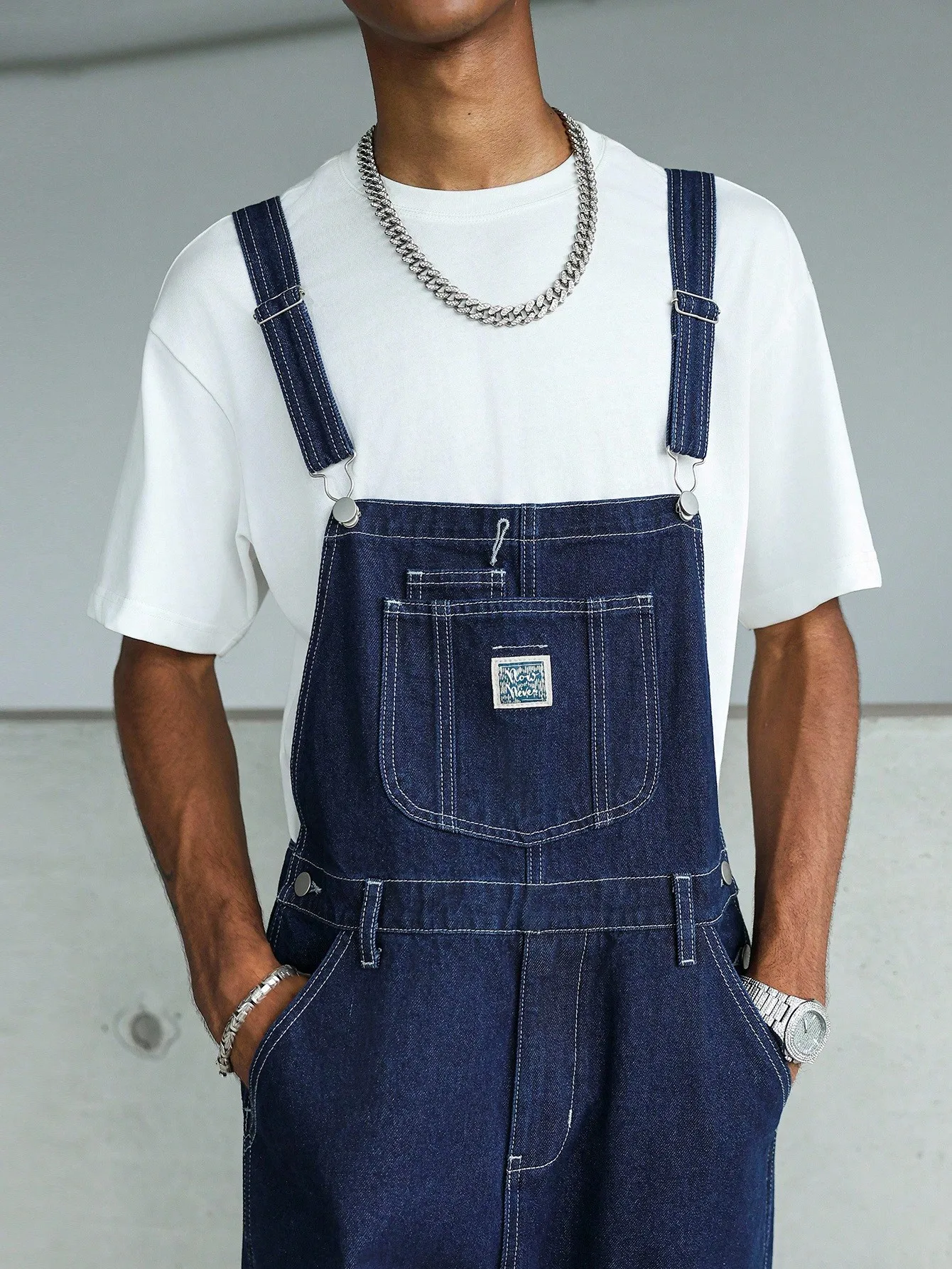 High-quality blue washed multi-pocket denim cargo pants with adjustable shoulder straps, perfect for casual wear in all seasons.