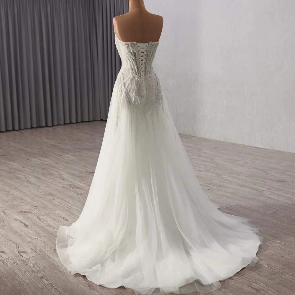 فستان زفاف من Fساتين زفاف بدون حمالات مطرز بالكريستال بدون أكمام وأربطة من الخلف فستان زفاف مثير