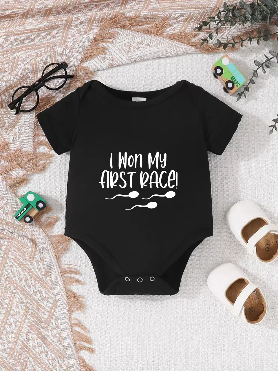 Playful letter-printed baby short-sleeve triangle bodysuit. Button closure for easy dressing