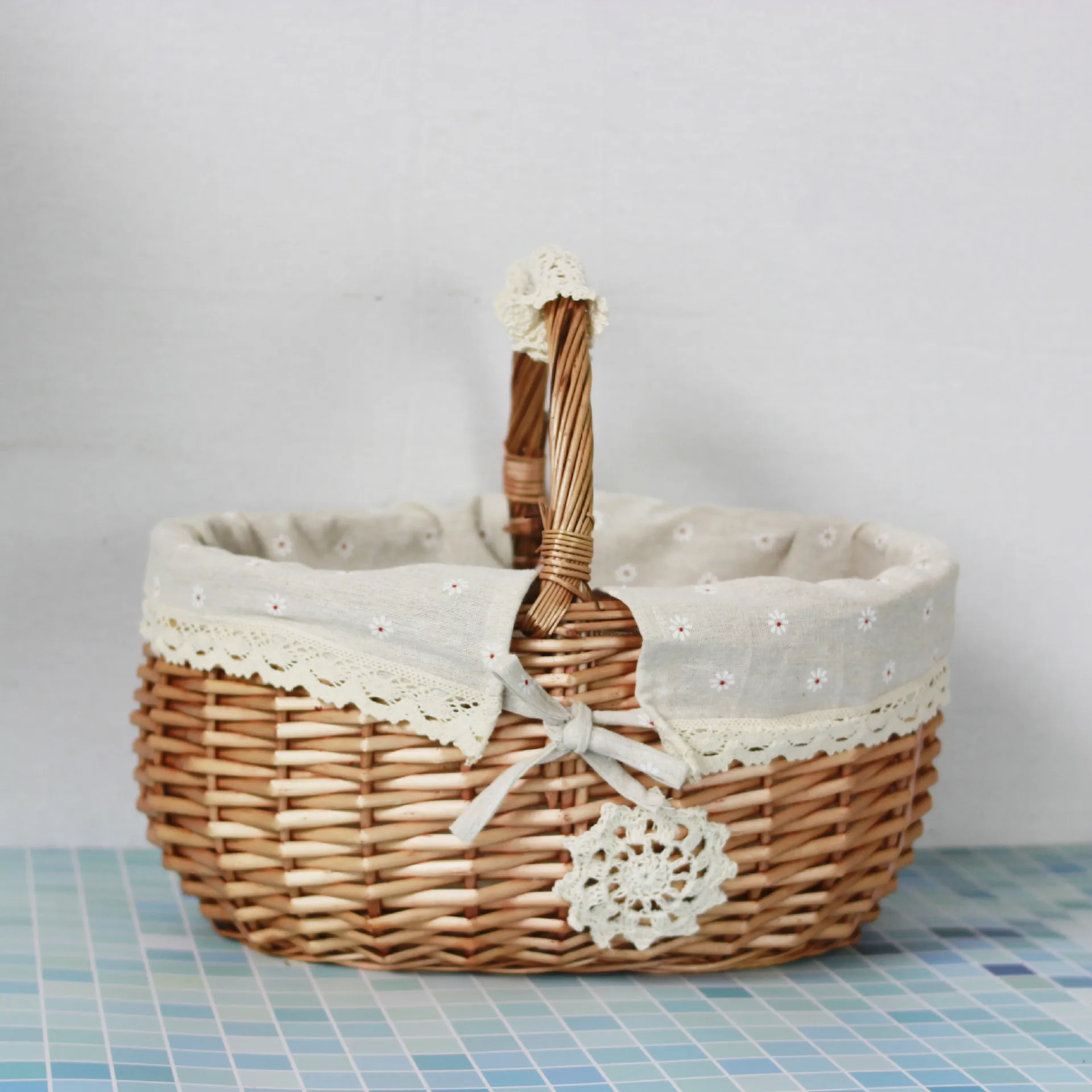 A wicker rattan woven white flower bow flower child basket Wedding stage beautiful decorative house dress picnic storage blue