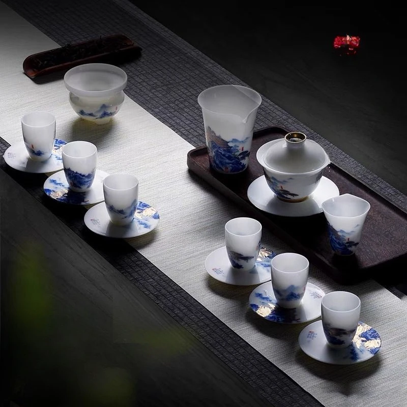 

High-end ice jade porcelain kung fu tea set cover bowl set leadership holiday gifts high mountains and flowing water