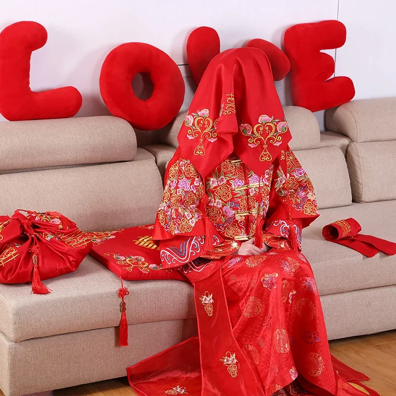 Wedding cushion with red sequins sitting on the blessing cushion