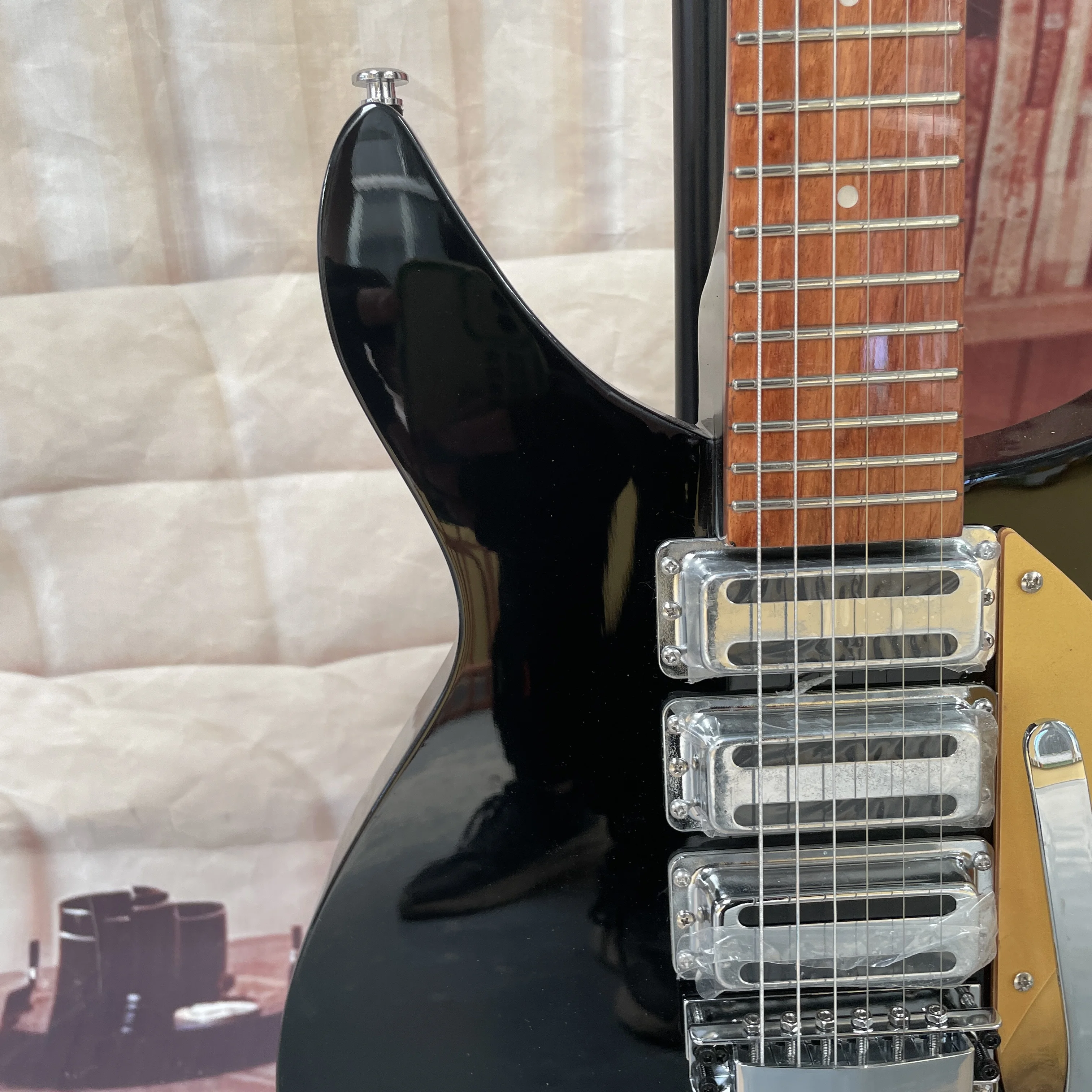 6-string electric guitar with a black glossy finish and retro gold fanned pickguard guitars, a vintage rock player's electric gu