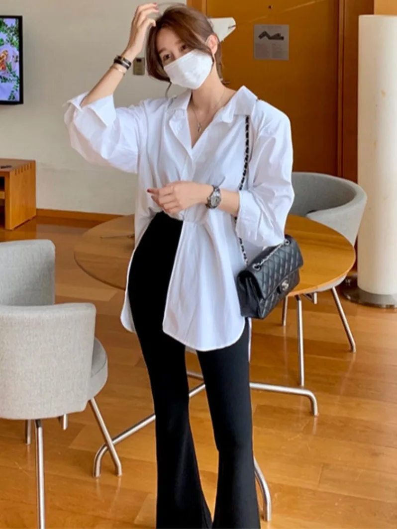 เสื้อยืดแฟชั่นลำลองผู้หญิงสไตล์ชิคต้นฤดูใบไม้ร่วงหลวมแขนยาวคอตั้งไม่สมมาตรด้านข้างผ่าด้านข้าง