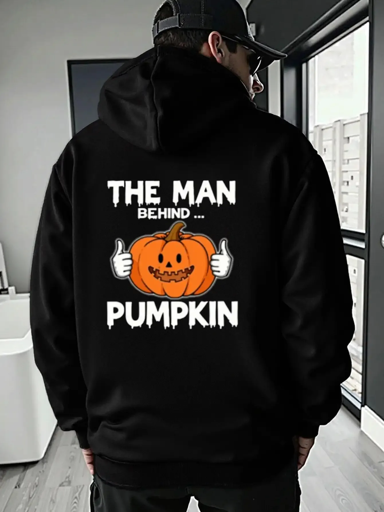 

Halloween Pumpkin Hoodie - Black Hooded Sweatshirt with "The for Man Behind The Pumpkin" Graphic, Cozy Fleece-Lined Interior