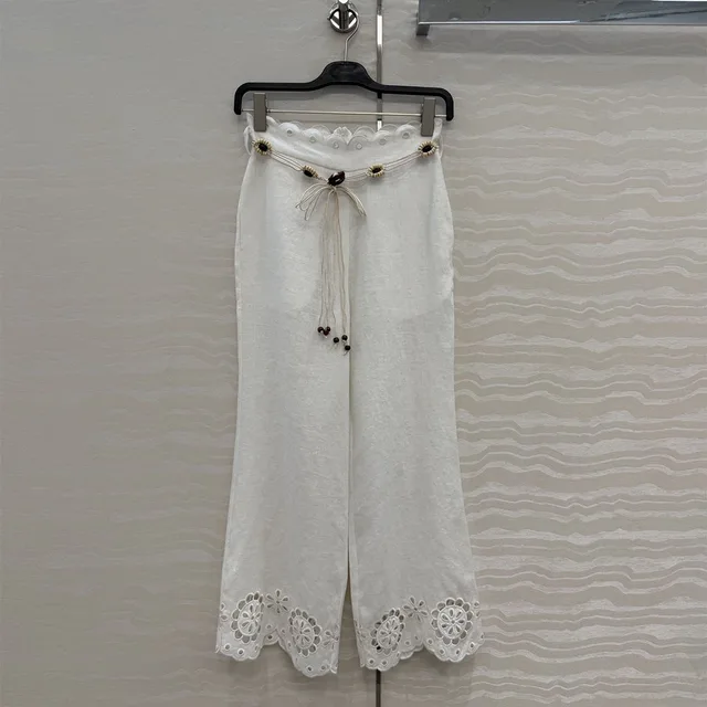 Pantalones de lino con cinturón de crochet, florales y acampanados