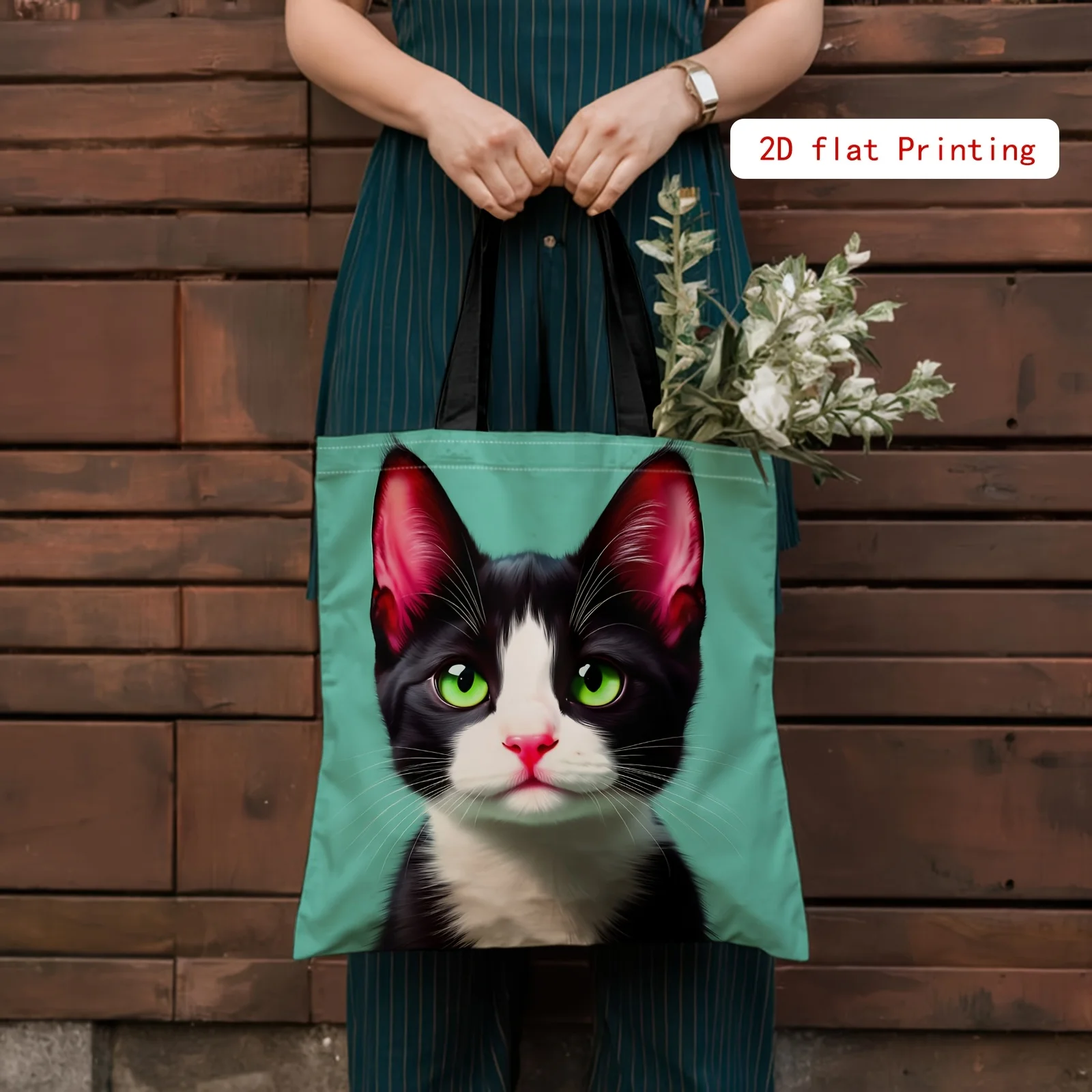 A Stylish 2D Printed Tote Bag Featuring a Cute Black And White Cat with Green Eyes. This Adorable Animal-Themed Tote
