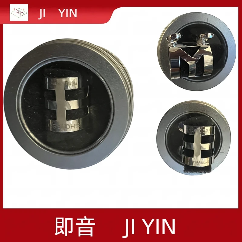 Selmer tenor saxophone metal ligature, mirror-polished stainless steel, stabilizes airflow.