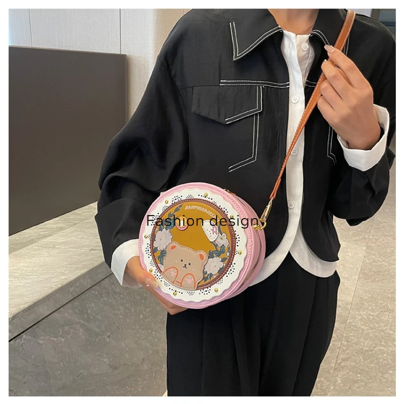 

High-end niche design women's bag, 2026 spring new style, fashionable lightweight hollow-out printed small round bag