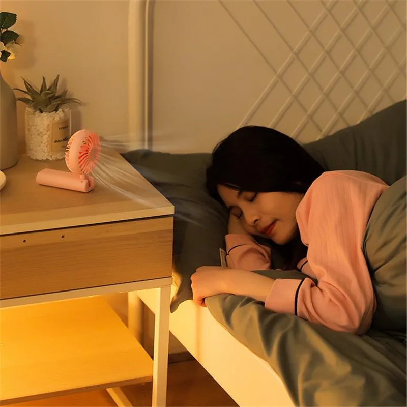 New foldable hand-held small fan Mini portable desktop fan Simple shape, strong wind speed, driven by two AA batteries