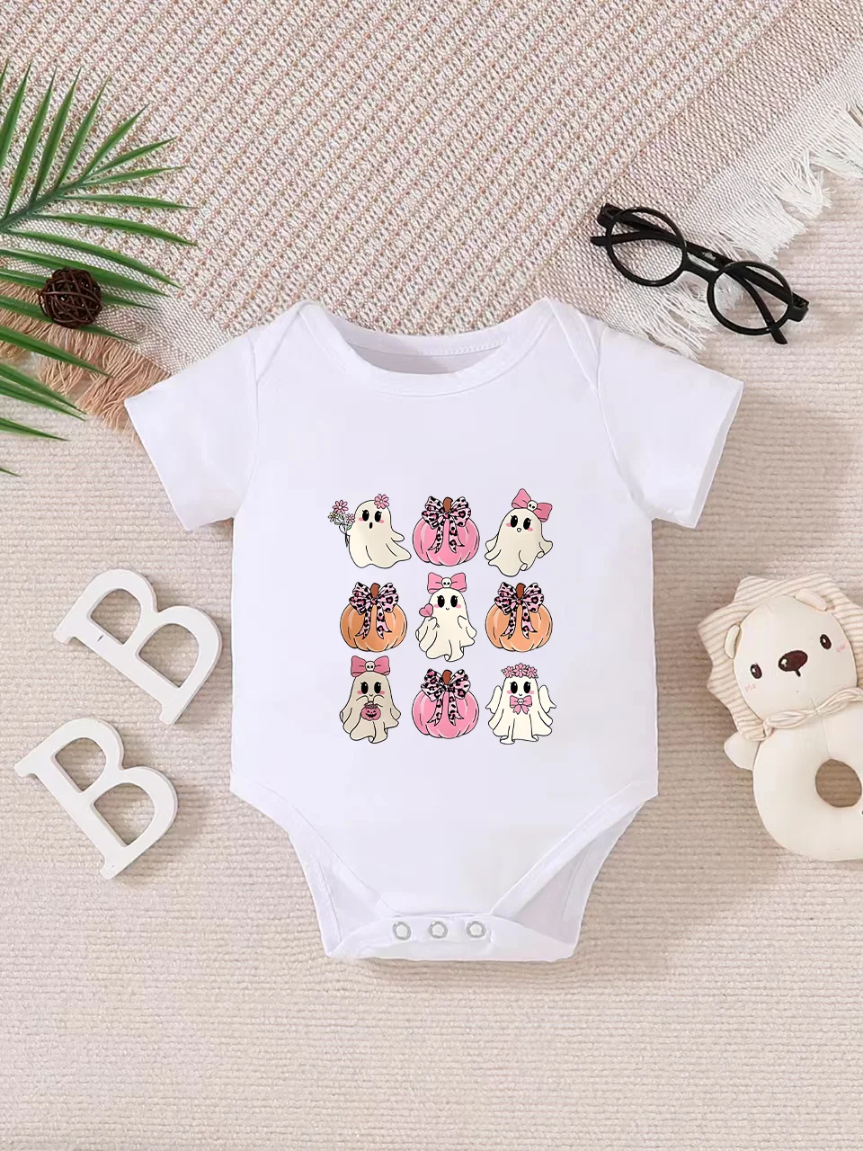 Playful letter-printed baby short-sleeve triangle bodysuit. Button closure for easy dressing, machine washable