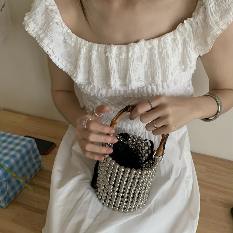 Bolso de perlas con asa de bambú, bolso de lujo con cuentas para fiesta de noche, bolsos de diseñador, bolso de cubo tejido hueco, embrague de boda hecho a mano, nuevo