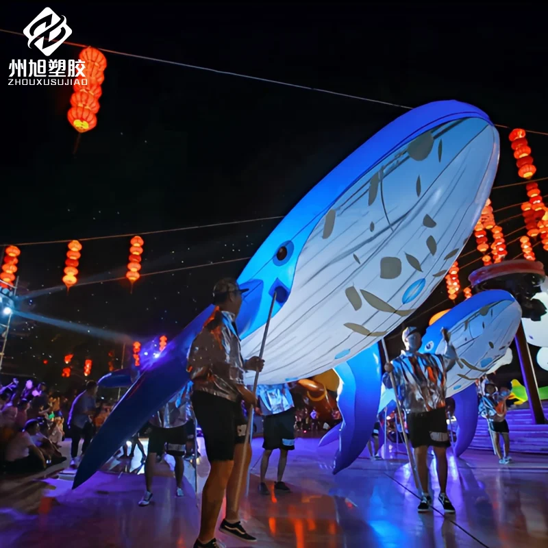 Inflatable interactive props for marine life parade performances with hands holding simulated dolphins and whales