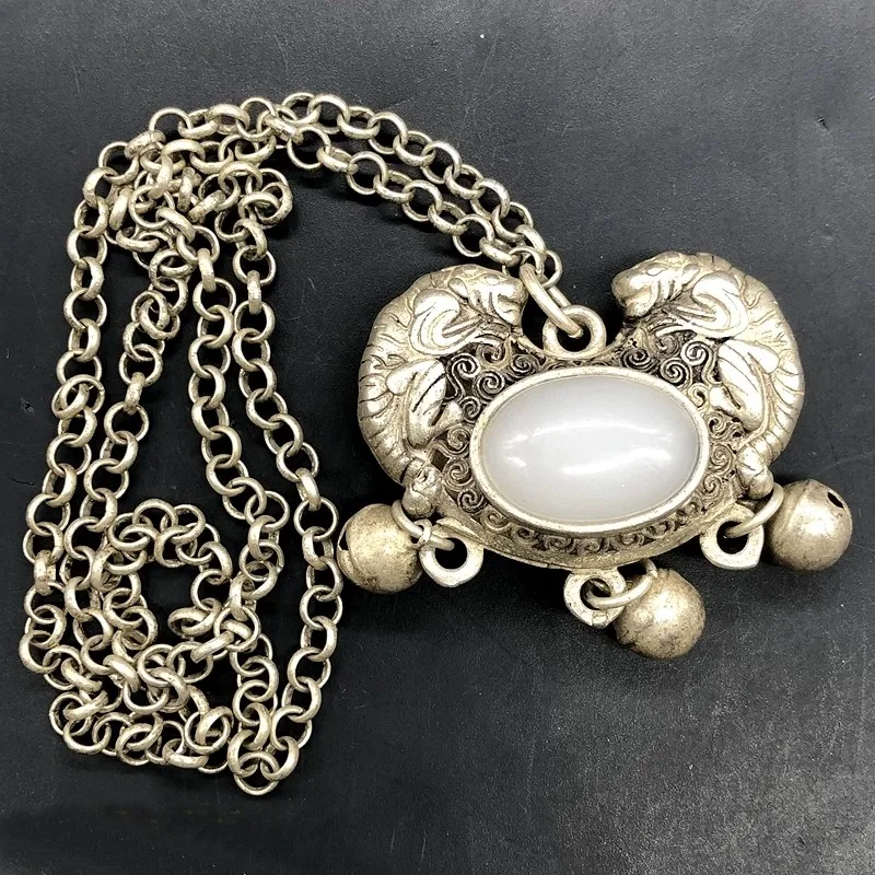 

Antique collection of jade pieces from the Qing Dynasty, featuring a pendant of the mythical creature Pi Xiu made of Hetian jade