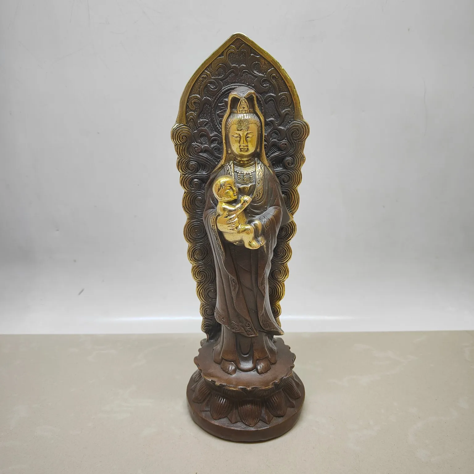 

A backlit statue of Guanyin, the Bodhisattva of Compassion, holding a child.),Free shipping
