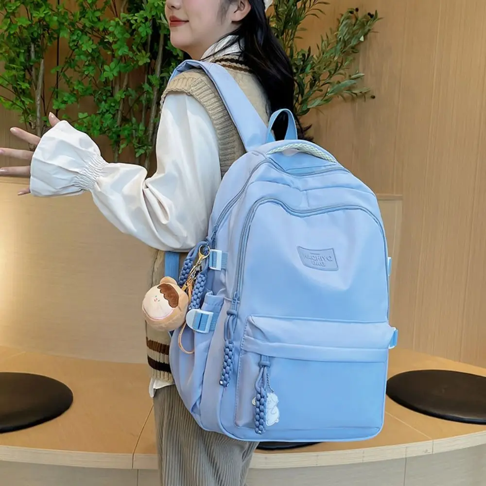 

Casual Versatile Smiling Doll Pendant Backpack Large Capacity Lightweight Schoolbag Nylon Travel Bag Women Girl