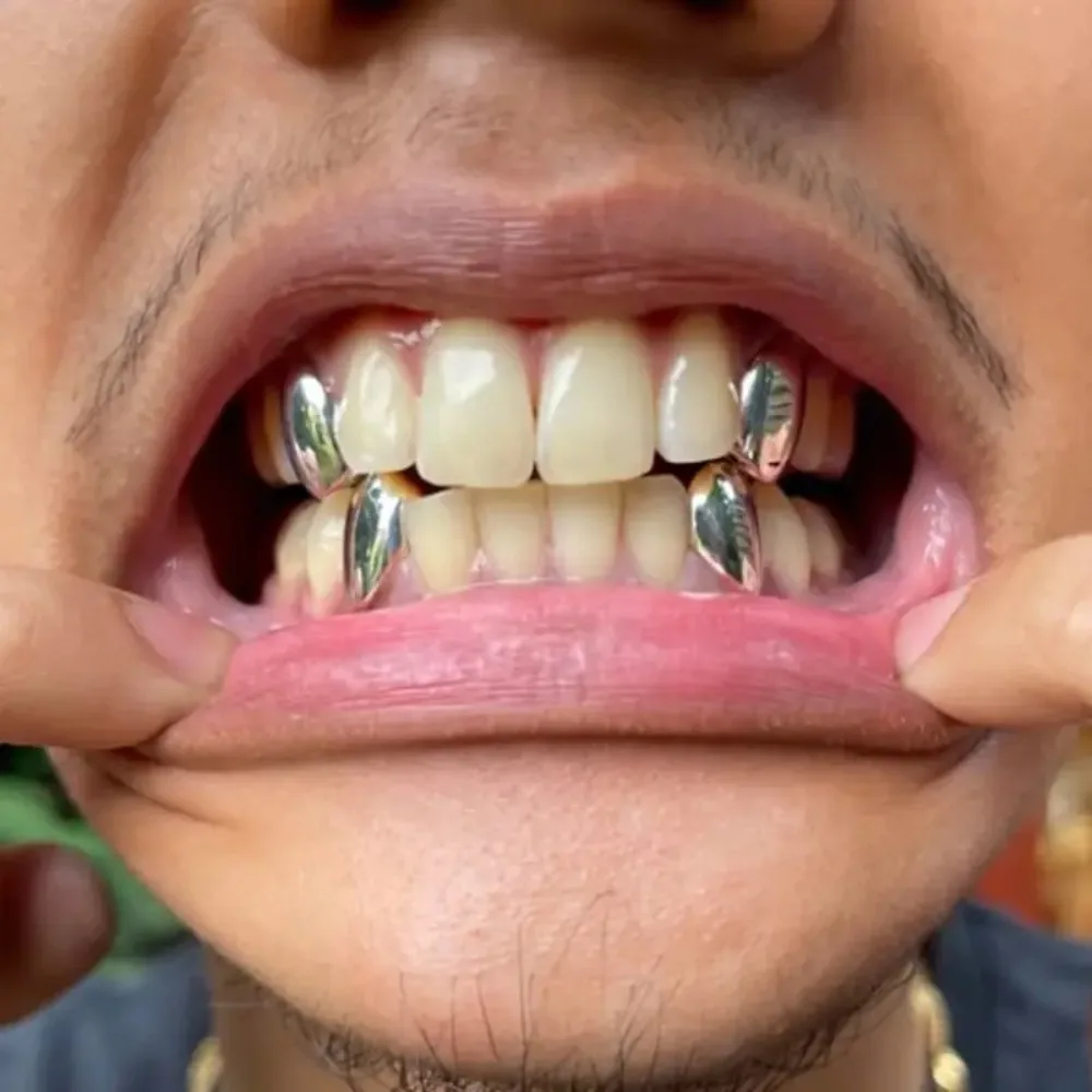 Hip-hop geometría punta chapada en oro dientes de tigre soportes parrillas dentales para mujeres hombres colmillos de vampiro joyería de acero inoxidable de Halloween