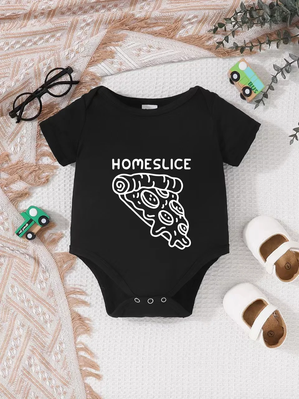 Playful letter-printed baby short-sleeve triangle bodysuit. Button closure for easy dressing