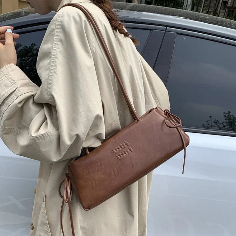 

Trendy Bucket Bag For Ladies In Soft Suede Leather With Drawstring Closure And Modern Sleek Silhouette