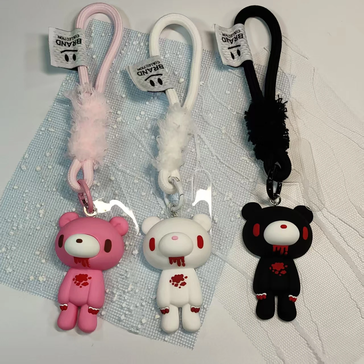 These edgy bear keychains come in pink, white, black. With fluffy accents and bold designs, they add a cool vibe to keys/bags.